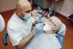an old man is getting dental implant treatment
