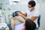 a lady is getting dental bridge treatment from a dentist