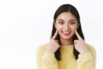 a young girl is smiling after getting invisalign treatment