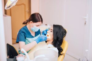 a dentist is cleaning a patient's teeth