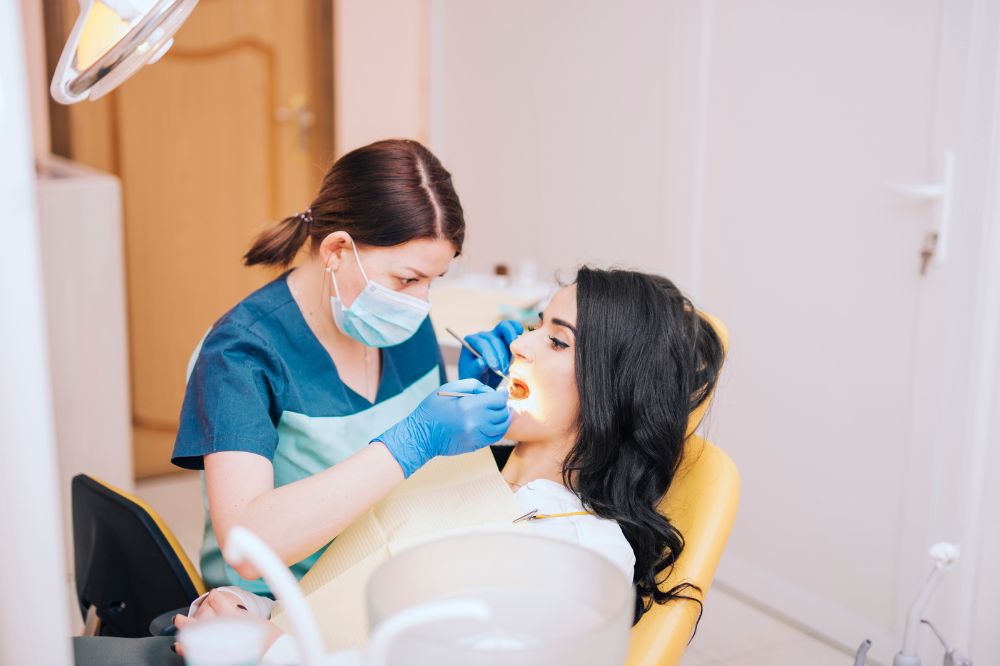 a dentist is cleaning a patient's teeth