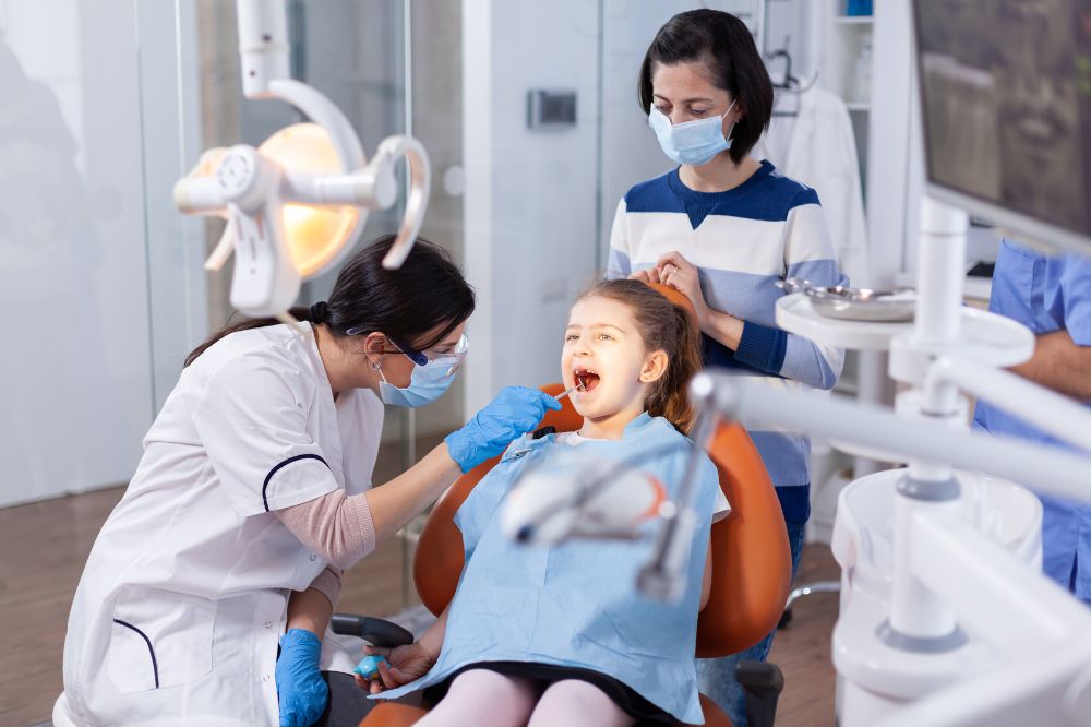 kid getting dental treatment to avoid cavities