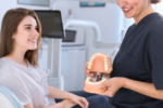 a lady dentist showing dental implant sample to a lady