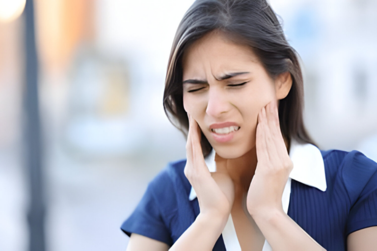 a girl is holding her jaws because of tmj pain