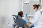 a lady dentist is examine a patient's teeth